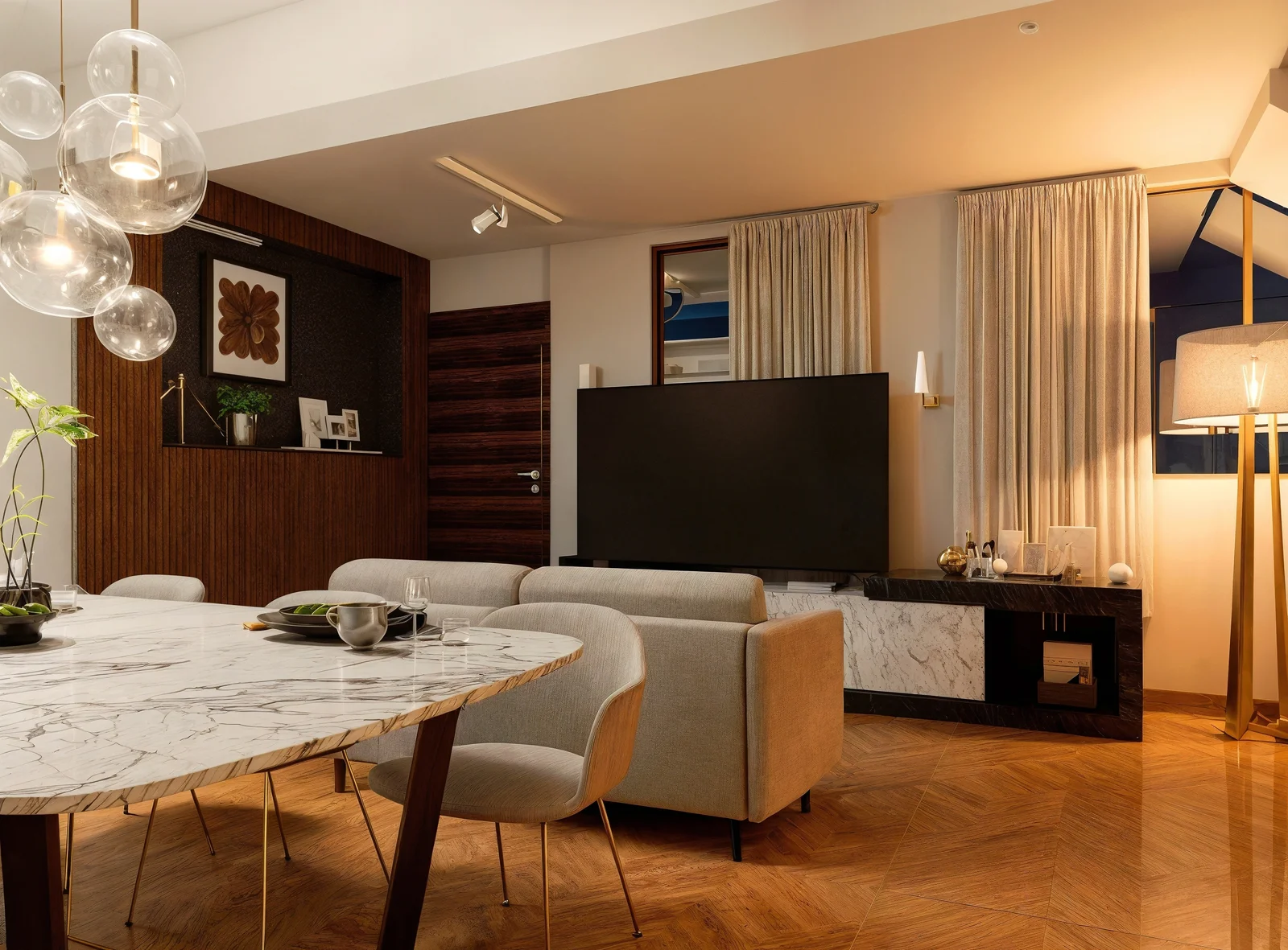 Sala de departamento dúplex con diseño moderno y doble altura en Origen Residencial